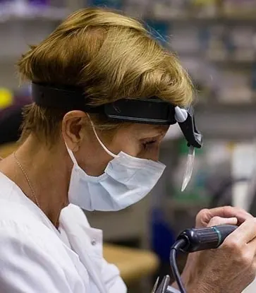 A technician finishing a restoration in the in-house laboratory.